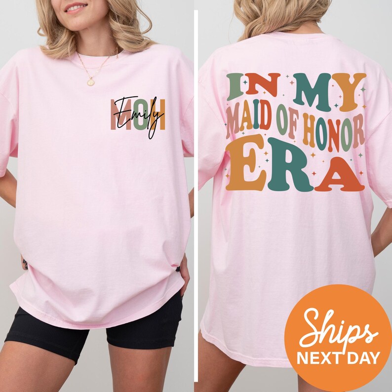 a woman wearing a pink shirt that says i'm my maid of honor era