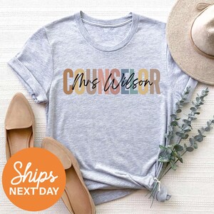a t - shirt with the word's name on it next to a hat