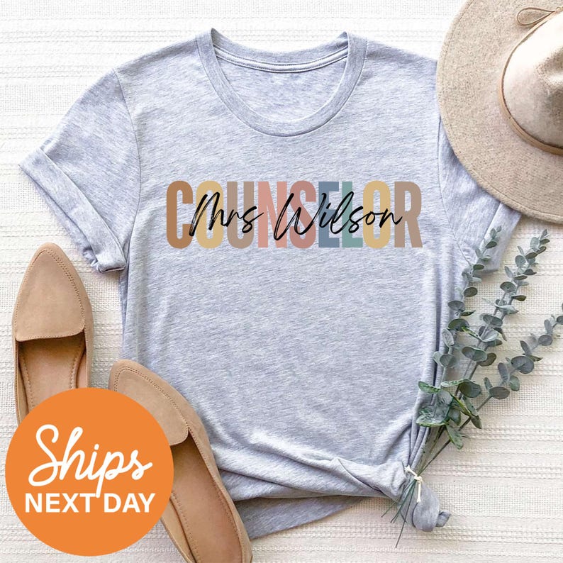 a t - shirt with the word's name on it next to a hat