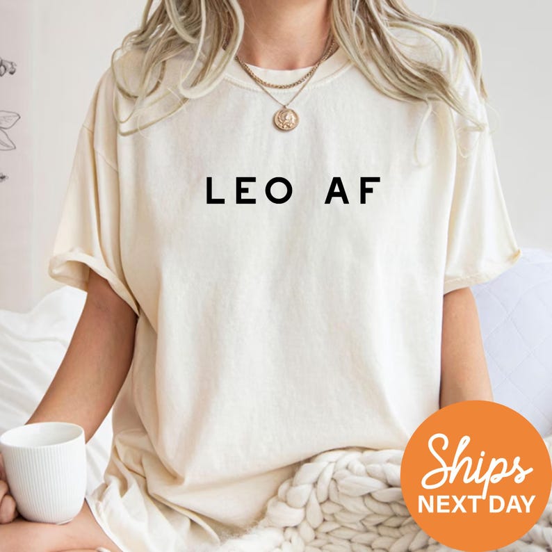 a woman sitting on a bed holding a cup of coffee