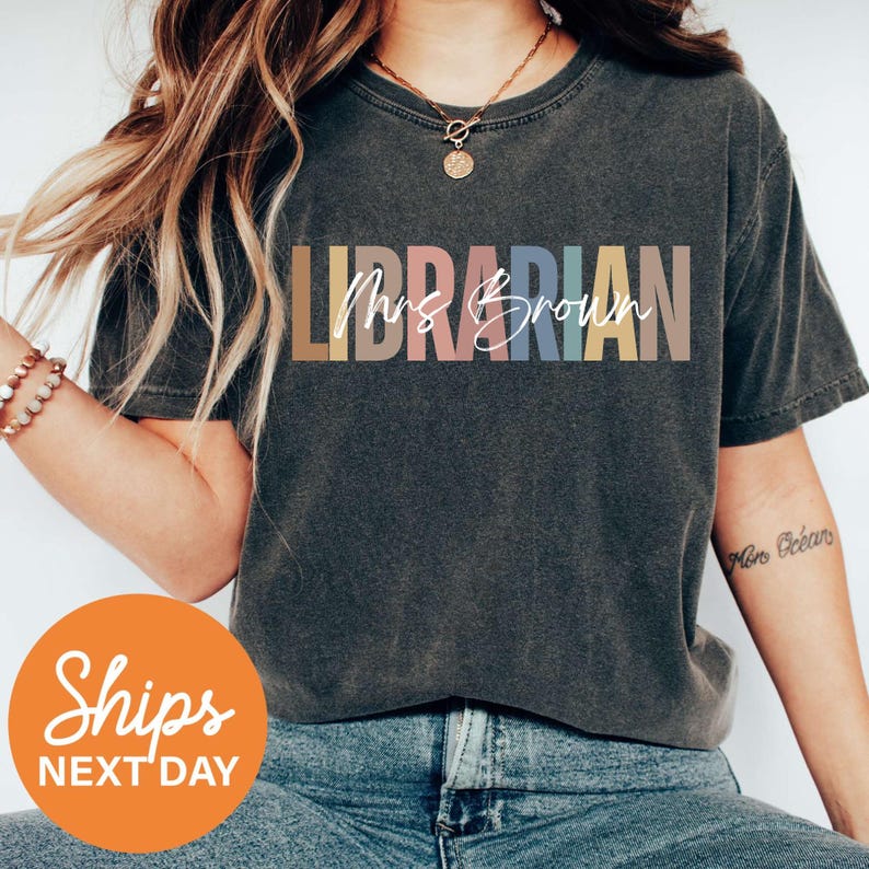 a woman with long hair wearing a shirt that says librarian