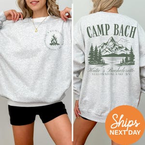 a woman wearing a sweatshirt that says camp bach