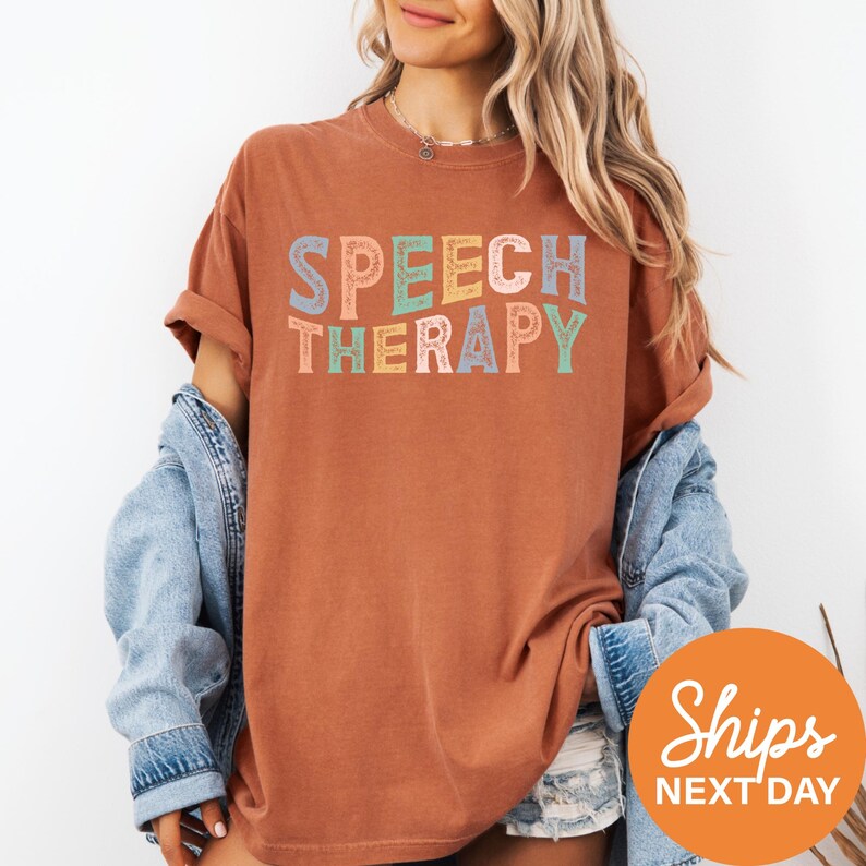 a woman wearing a t - shirt that says speech therapy