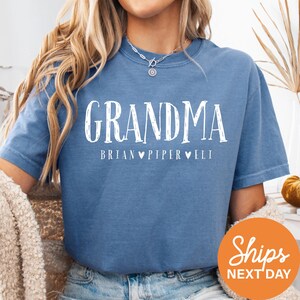 a woman wearing a blue grandma t - shirt