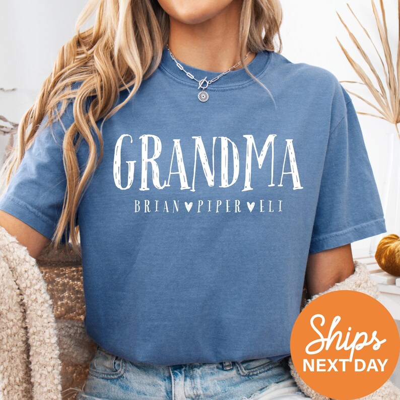 a woman wearing a blue grandma t - shirt