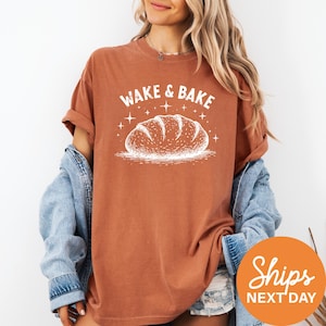 a woman wearing a t - shirt that says wake and bake