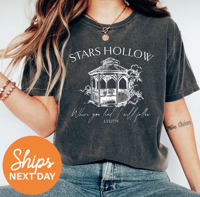a woman wearing a t - shirt that says stars hollow