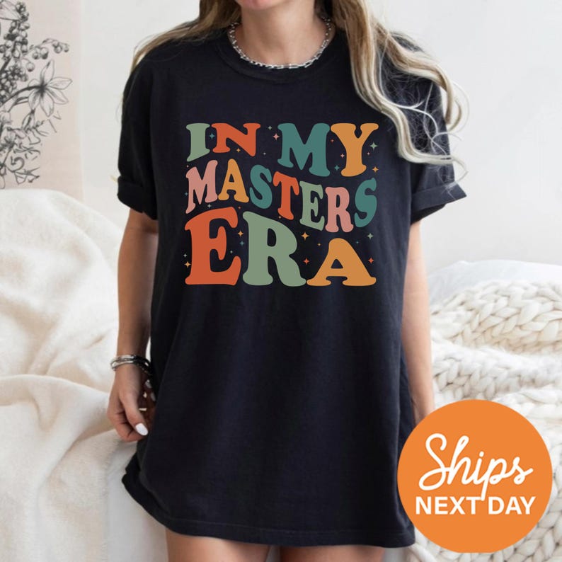 a woman wearing a black shirt that says in my masters era