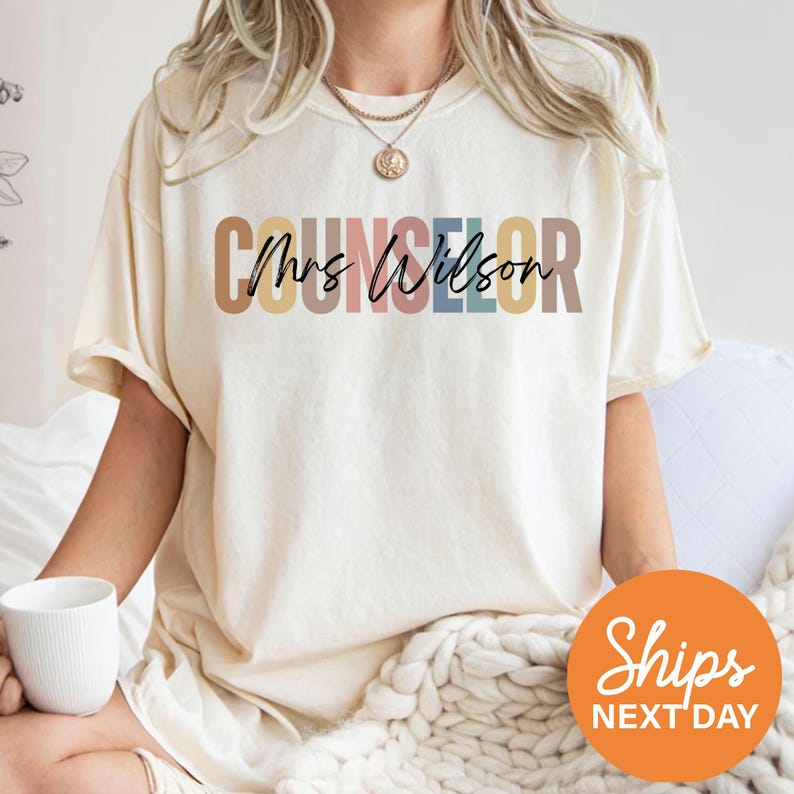 a woman sitting on a bed with a cup of coffee