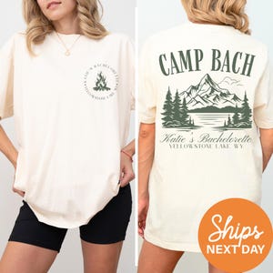 a woman standing next to a man wearing a shirt that says camp bach