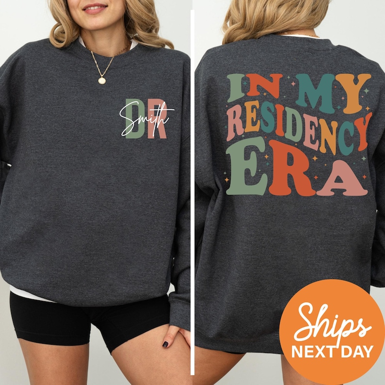 a woman wearing a sweatshirt that says in my residence era