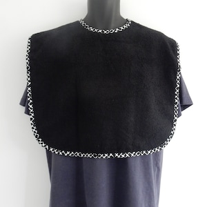 May include: Black bib with white stitching around the edges. The bib is made of a soft, absorbent material.