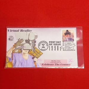 May include: A first day of issue stamp from May 2, 2000, celebrating the 1990s. The stamp features a person wearing a virtual reality headset and the text "Virtual Reality". The stamp is on a white envelope with the text "First Day of Issue 1990s" and "Celebrate The Century".