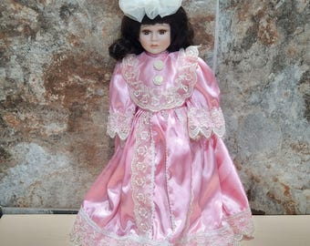 Vintage Porcelain Doll Dark Hair Pink Dress Lace Trim White Bonnet