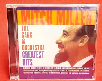 May include: CD case featuring a colour photo of Mitch Miller, the Gang & Orchestra, with the title "Greatest Hits" and a list of songs on the back.