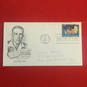 May include: An envelope with a portrait of Robinson Jeffers, a U.S. poet, and a stamp. The envelope is postmarked August 13, 1973, in Carmel, CA. Text includes "First Day of Issue" and the recipient's address.