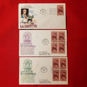 May include: Three envelopes with stamps commemorating the 200th birthday of Marquis de Lafayette. The envelopes are white with red and blue accents. The stamps feature a portrait of Lafayette and the text "Lafayette Bi-Centennial".