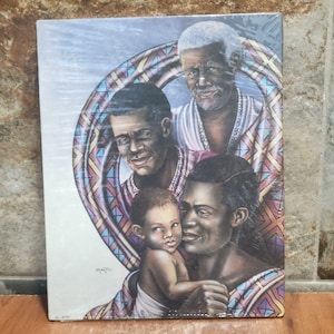 May include: A framed print depicting a family portrait. The artwork features four figures: an elderly man, two adult men, and a baby. The figures are of African descent, with detailed facial features and traditional clothing. The background includes a decorative circular pattern.