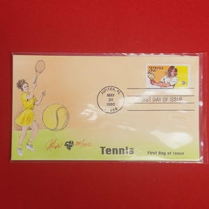 May include: A yellow first day of issue envelope with a tennis stamp featuring a woman playing tennis. The envelope has a postmark from Jupiter, Florida, May 20, 1995. The envelope is numbered 84/100 and says "Tennis" at the bottom.