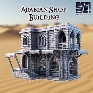 Puede incluir: Un edificio de tienda árabe en miniatura con fachada de piedra. La estructura de dos pisos presenta puertas y ventanas arqueadas, un balcón y un toldo. El texto "ARABIAN SHOP BUILDING" se muestra encima del edificio.