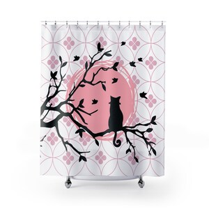 May include: A black silhouette of a cat sitting on a branch of a tree with pink leaves. The tree is in front of a pink sun with a white background. The background also has a pattern of pink circles and flowers.