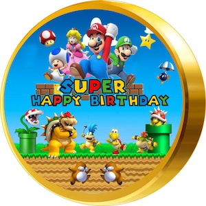 May include: A round, gold-rimmed cake topper featuring characters from the Super Mario video game series. The characters include Mario, Luigi, Peach, Toad, Bowser, and Yoshi. The text "SUPER HAPPY BIRTHDAY" is written in colorful letters across the top.