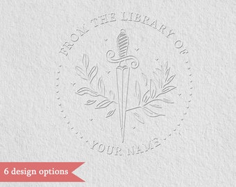 May include: A black and white illustration of a dagger with leaves and the text "From the Library of... Your Name" in a circle.