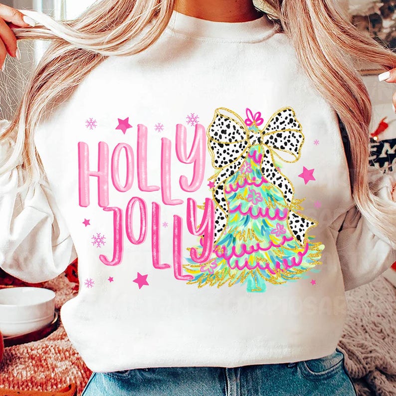 May include: White sweatshirt with a pink "Holly Jolly" graphic and a green and gold Christmas tree with a black and white polka dot bow.