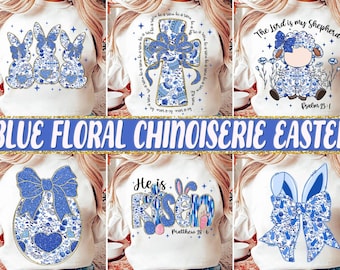 May include: Six different designs of white sweatshirts with blue floral chinoiserie Easter designs. The designs include bunnies, a cross, a lamb, an egg, a bow, and the words "He is Risen" with a bunny.