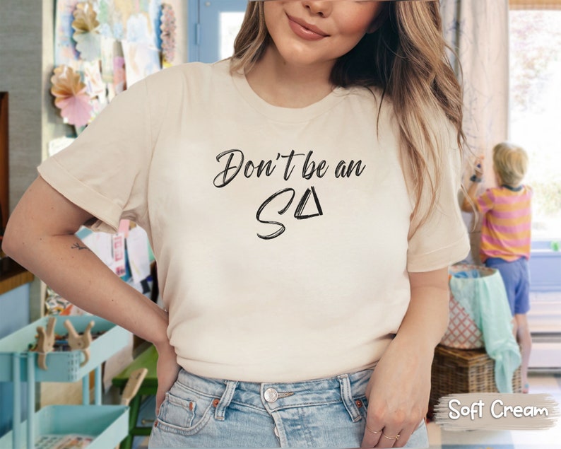 T-shirt featuring text Don't be an S Delta in a paintbrush font. Playful reminder for Registered Behavior Technicians (RBTs) and Applied Behavior Analysis (ABA) therapists.