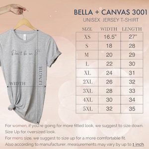 May include: A size chart for a unisex jersey t-shirt. The chart shows the width and length measurements in inches for sizes XS to 5XL. The text "Don't be an S" is printed on the t-shirt.