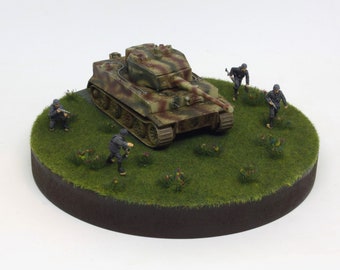 Built tank Tiger I Kpfw. VI in 1/72 scale on a round wooden base plate with grass