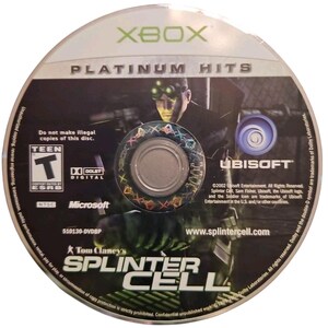 May include: A silver Xbox Platinum Hits game disc for Tom Clancy's Splinter Cell. The disc features a character graphic and the Ubisoft logo. The disc is rated Teen by the ESRB and includes Dolby Digital.