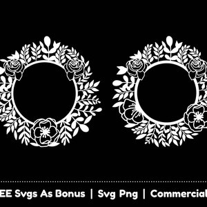May include: Two white floral wreaths with a circular frame in the center. The wreaths are made of leaves and flowers, including roses and other blooms.