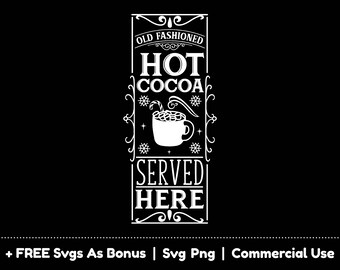 May include: A white sign with black text that reads "Old Fashioned Hot Cocoa Served Here". The sign has a decorative border and a picture of a mug of hot cocoa with marshmallows.