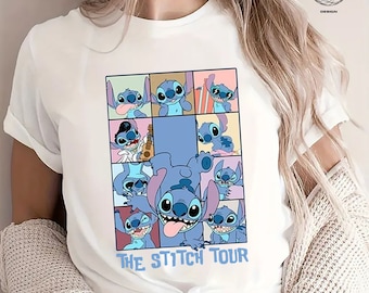 May include: White t-shirt with a graphic of Stitch from Lilo & Stitch. The design shows Stitch in different poses, with the text "THE STITCH TOUR" in blue. The shirt is worn with a light-coloured cardigan and blue jeans.