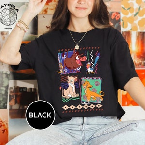 May include: Black t-shirt with a graphic print of characters from the Lion King movie. The characters are Simba, Nala, Pumbaa, and Zazu. The graphic is surrounded by a colorful geometric pattern.