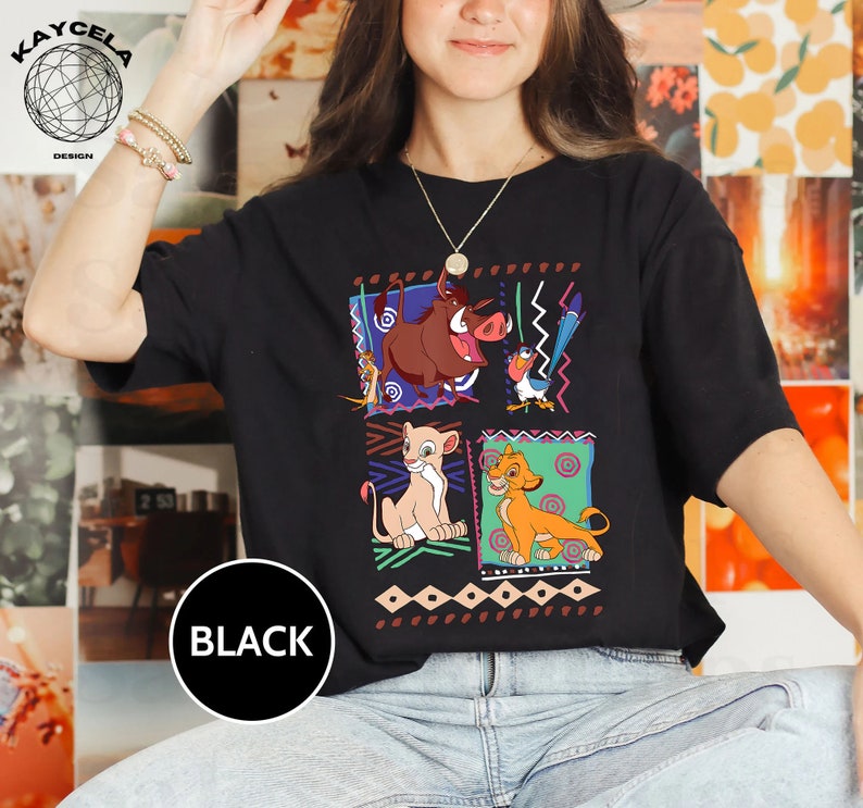 May include: Black t-shirt with a graphic print of characters from the Lion King movie. The characters are Simba, Nala, Pumbaa, and Zazu. The graphic is surrounded by a colorful geometric pattern.