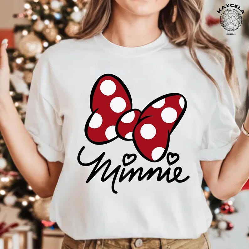 May include: White t-shirt with a red bow with white polka dots and the word "Minnie" in black script.