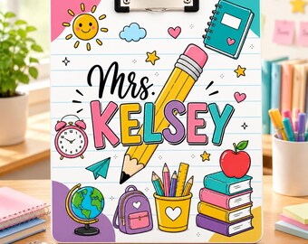 May include: A white clipboard with a metal clip featuring a colourful school-themed design. The text reads Mrs. KELSEY in large letters, surrounded by illustrations of a yellow pencil, a red apple, books, a globe, a backpack, and a clock.