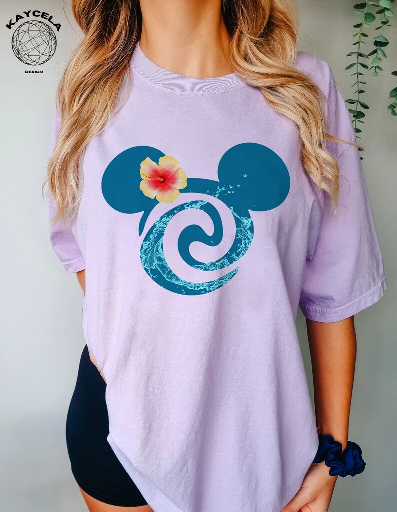 May include: A lavender t-shirt with a blue Mickey Mouse silhouette featuring a wave design and a pink hibiscus flower.