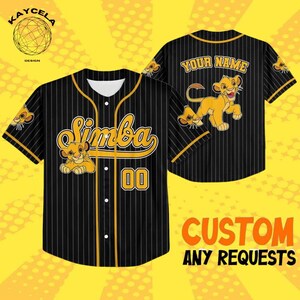 May include: Black baseball jersey with yellow pinstripes, featuring the name "Simba" and the number "00" in yellow. The jersey has a cartoon lion graphic and the text "YOUR NAME" on the back. The jersey is a custom design.