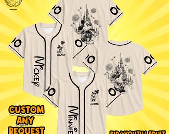 May include: Beige baseball jerseys with black trim, featuring button-down fronts, short sleeves, and black circular patterns. Designs include line-art illustrations of Mickey and Minnie Mouse, castle silhouettes, fireworks, and the text Mickey or Minnie.