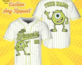 May include: White baseball jersey with green pinstripes and accents. Features a cartoon character graphic and the text "Mike Wazowski" on the front, and "YOUR NAME" on the back. Includes the number "88". The text "Custom Any Request" is also visible.