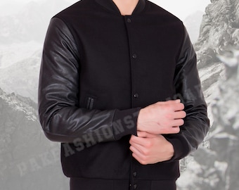 May include: Black varsity jacket with black leather sleeves. The jacket has a button-up front, a ribbed collar, and a ribbed hem. The sleeves are a shiny black leather material.