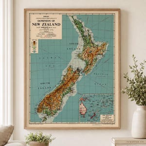 May include: A vintage-style wall map titled Philips' Comparative Series School Room Map of Dominion of New Zealand. The map features a teal ocean background, detailed topography in shades of green and brown, a scale, and an inset map of islands.