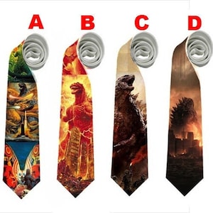 May include: Four neckties with different Godzilla-themed designs. Each tie features a unique illustration of the iconic monster in various scenes. The ties have a light gray rolled top and a pointed bottom.