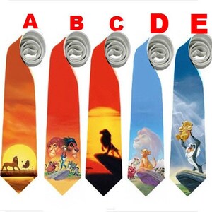 May include: Five neckties with colorful designs featuring characters and scenes from a popular animated film. The ties have a light gray knot and a vibrant, detailed print. The designs include a sunset, characters, and a silhouette of a lion.