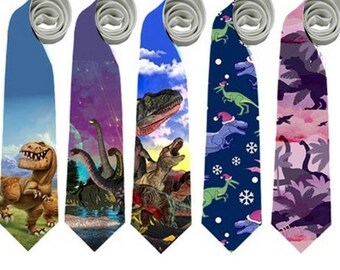 May include: Five neckties with dinosaur designs. Each tie features a different pattern: a blue tie with a cartoon T-Rex, a purple tie with Brontosaurus, a blue tie with a T-Rex, a navy tie with dinosaurs wearing Santa hats, and a pink camouflage tie with dinosaur silhouettes.