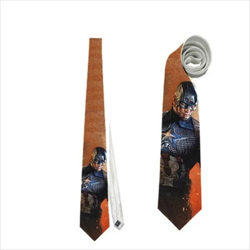 May include: A Captain America themed necktie. The tie features a brown background with an image of Captain America in his uniform. The tie is made of a smooth fabric and has a classic pointed end.